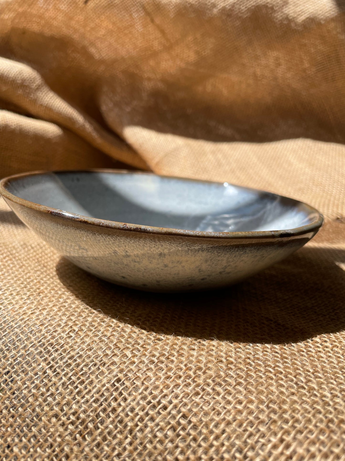 Glossy bowl in light blue, smooth, handmade ceramics